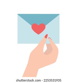 An envelope with a love message in a women's hand, girl holds an envelope with a love message