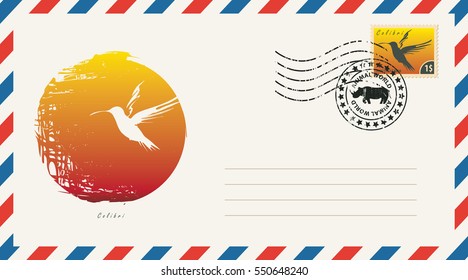 an envelope with a postage stamp with drawing hummingbird bird on a background of the sun