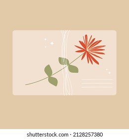 Un sobre atado con un hilo de papel kraft con una flor silvestre.