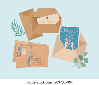 Envelopes, post cards, post stamps, craft paper letters and green branch of green leaves top view