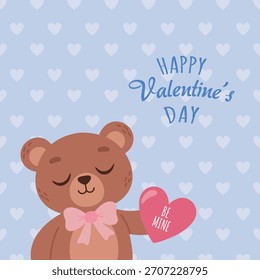 EPS10 A cute teddy bear holding a heart-shaped Valentine’s Day card on a light blue background