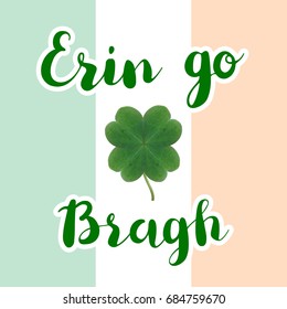 Erin go bragh lettering typography with realistic four leaf clover on irish flag background.