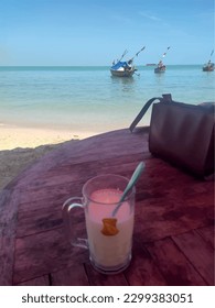 Escape to paradise with this mesmerizing beach photo.Immerse yourself in the beauty of crystal-clear waters, pristine sand, and lush greenery.This picture-perfect scene is a soothing balm for the soul