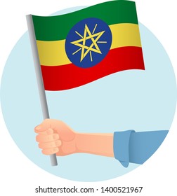 Ethiopia flag in hand. Patriotic background. National flag of Ethiopia vector illustration