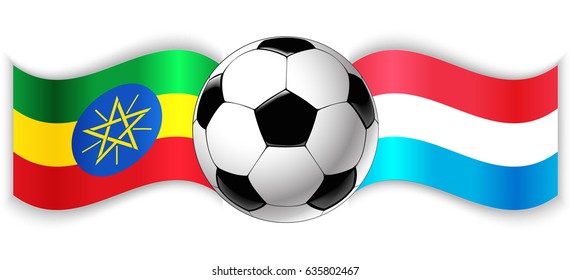 Ethiopian and Luxembourgish wavy flags with football ball. Ethiopia combined with Luxembourg isolated on white. Football match or international sport competition concept.