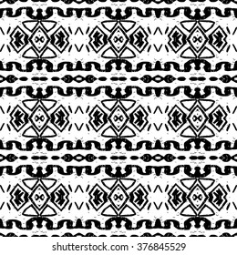 Ethnic Aztec pattern. Striped hand painted aztec vector seamless pattern with ethnic and tribal motifs, zigzag lines, brushstrokes and splatters of paint black and white colors Vector illustration.
