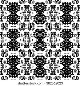 Ethnic Aztec pattern. Striped hand painted aztec vector seamless pattern with ethnic and tribal motifs, zigzag lines, brushstrokes and splatters of paint black and white colors Vector illustration.