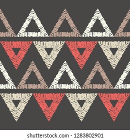Ethnic boho seamless pattern. Mosaic of painted triangles. Embroidery on fabric. Traditional ornament. Tribal pattern. Folk motif. Can be used for wallpaper, textile, invitation card, wrapping, web.