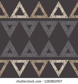 Ethnic boho seamless pattern. Mosaic of painted triangles. Embroidery on fabric. Traditional ornament. Tribal pattern. Folk motif. Can be used for wallpaper, textile, invitation card, wrapping, web.