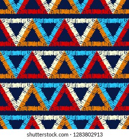 Ethnic boho seamless pattern. Mosaic of painted triangles. Embroidery on fabric. Traditional ornament. Tribal pattern. Folk motif. Can be used for wallpaper, textile, invitation card, wrapping, web.