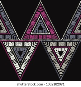 Ethnic boho seamless pattern. Triangles. Embroidery on fabric. Patchwork texture. Weaving. Traditional ornament. Tribal pattern. Folk motif. Can be used for wallpaper, textile, invitation card.