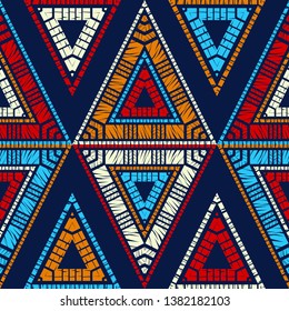 Ethnic boho seamless pattern. Triangles. Embroidery on fabric. Patchwork texture. Weaving. Traditional ornament. Tribal pattern. Folk motif. Can be used for wallpaper, textile, invitation card.