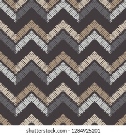 Ethnic boho seamless pattern. The zigzag of the painted stripes. Embroidery on fabric. Traditional ornament. Tribal pattern. Folk motif. Can be used for wallpaper, textile, invitation card, wrapping. 