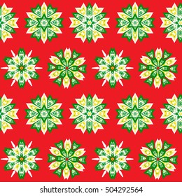 Ethnic Christmas seamless pattern on red background. Boho textile print. New Year wallpaper. Winter abstract wrapping with snowflakes.