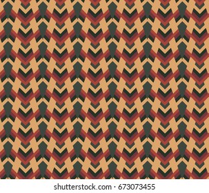 Ethnic design. Seamless pattern with traditional tribal motifs, zigzag lines, triangles in bright yellow, orange and brown colors. Repeating geometric mesh tiles. Scrapbook background, wrapping paper.
