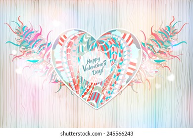 Ethnic patterned colored heart and feathers on the wood hand-drawn background / card for Valentine's Day