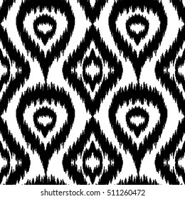 Ethnic seamless black and white pattern. Boho textile print. Geometric wallpaper with abstract rhombus and peacock feathers.