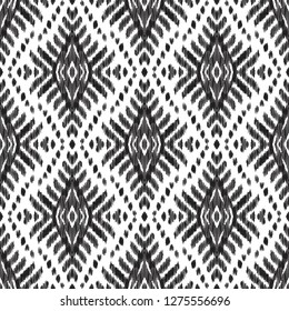 Ethnic seamless pattern. Boho ikat ornament. Can be used for textile, wallpaper, wrapping paper, greeting card background, phone case print. Black and white vector illustration. Tribal graphic design.