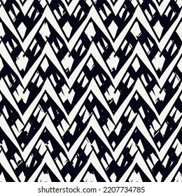 Ethnic seamless pattern. Freehand zigzag stripes print. Boho chic design background. Tribal style wallpaper. Brush wavy lines. Handdrawn geometric ornament. Chevron backdrop. Indigenous image.