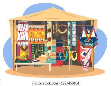 Ethnic souvenir street shop. Mexican street store with carpets, mats, ponchos, sombrero hats and jewelry.