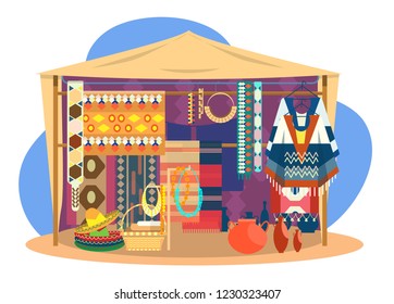 Ethnic souvenir street shop. Mexican street store with carpets, mats, ponchos, sombrero hats, jewelry and pottery.