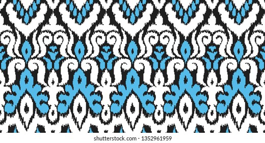 Ethnic style seamless pattern with ikat stylized ornament. Traditional ornamental textile design. Folklore handicraft repeating background.