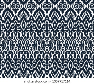 Ethnic style seamless pattern with ikat stylized ornament. Traditional ornamental textile design. Folklore handicraft repeating background.