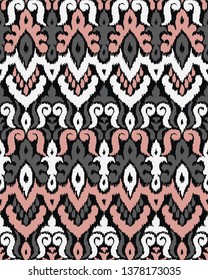 Ethnic style seamless pattern with ikat stylized ornament. Traditional ornamental textile design. Folklore handicraft repeating background.