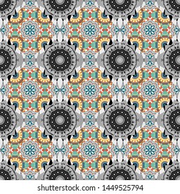 Ethnic and tribal motifs. Vector print in the bohemian style. Colored flowers, Mandalas and elements in a beige, gray and blue colors. Embroidery - seamless ornament.
