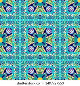 Ethnic vector seamless pattern. Colorful geometric ornamental background. Tribal repeat floral backdrop. Geometrical ornament with flowers, squares, lines, stripes, zigzag. Checkered bright design