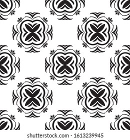 Ethnic vector seamless pattern with tiled motifs in black and white