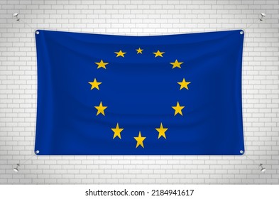European Union flag hanging on brick wall. 3D drawing. Flag attached to the wall. Neatly drawing in groups on separate layers for easy editing.