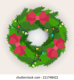 Evergreen circular pine of fir Christmas wreath decorated with red bows and a garland of colorful party lights to celebrate the season, on grey