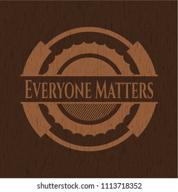  Everyone Matters badge with wooden background