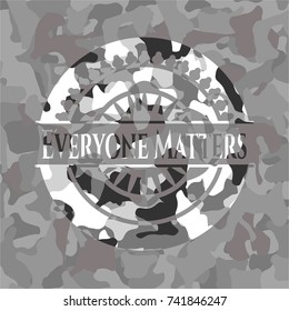 Everyone Matters written on a grey camouflage texture