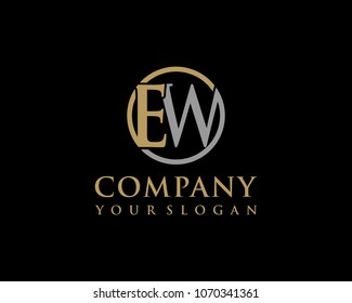EW initial letters looping linked circle elegant logo golden silver black background