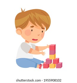 Excited Boy Sitting on the Floor in Nursery Playing Toy Blocks Vector Illustration