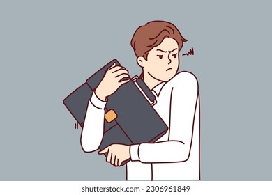Excited man with business bag in hands is trying to avoid loss and theft of important documents. Business man hugging bag with price of confidential information that competitors want to steal
