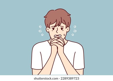 Excited man makes gesture of praying asking lord for help in solving problems that have arisen. Frightened guy praying and begging god to help him recover from disease or be saved for sinful act 