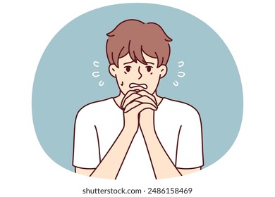 Excited man makes gesture of praying asking lord for help in solving problems that have arisen. Frightened guy praying and begging god to help him recover from disease or be saved for sinful act