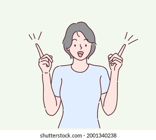 Excited young woman pointing fingers up at copy space isolated, ointing index fingers up commercial area. Hand drawn in thin line style, vector illustrations.