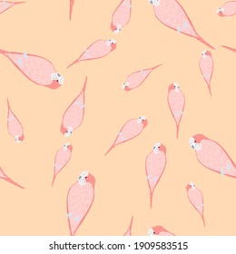 Exotic bird seamless pattern with pink colored parrot doodle shapes. Light orange background. Flat vector print for textile, fabric, gift wrap, wallpapers. Endless illustration.