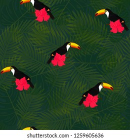 Exotic composition of toucans and tropical flowers on the background of palm leaves. Seamless vector pattern