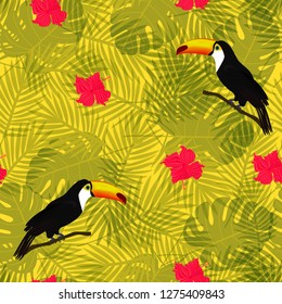 Exotic composition of toucans and tropical flowers on the background of palm leaves. Seamless vector pattern