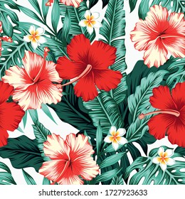 Exotic green tropical palm, fern leaves, vivid hibiscus, plumeria flowers seamless pattern on the white background. Jungle vector floral wallpaper.