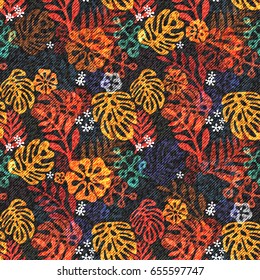 Exotic leaf seamless print on denim backdrop. Bright tropic leaves on a dark blue background, color graphics, blue jeans texture, hand-drawn vector.