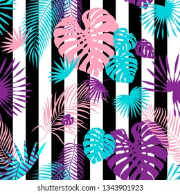 Exotic seamless pattern with palm and monstera leaves. Striped textile print with leaves