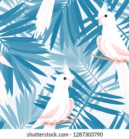 Exotic seamless pattern with a parrot and tropical leaves. Beautiful White Corella on the vine.