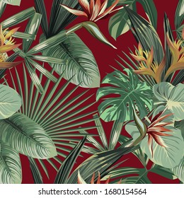 Exotic strelitzia, bird of paradise flowers and tropical palm, banana, monstera green leaves seamless vector pattern on red background. Beach creative wallpaper