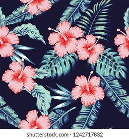 Exotic tropical flowers pink hibiscus green monstera palm leaves pattern seamless. Dark blue vector vintage wallpaper